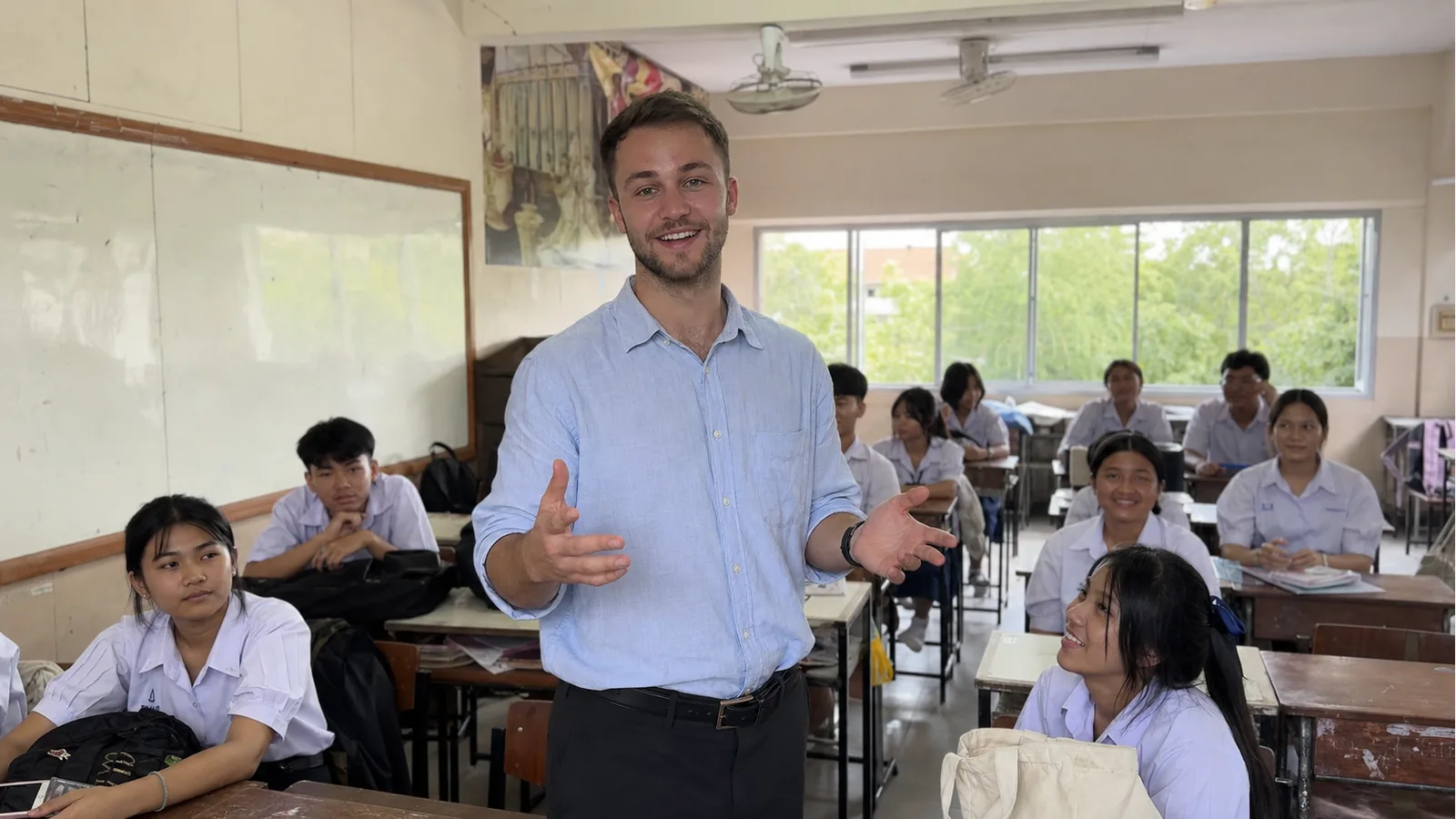 First-time foreign teacher smiling at the front of a Thai classroom