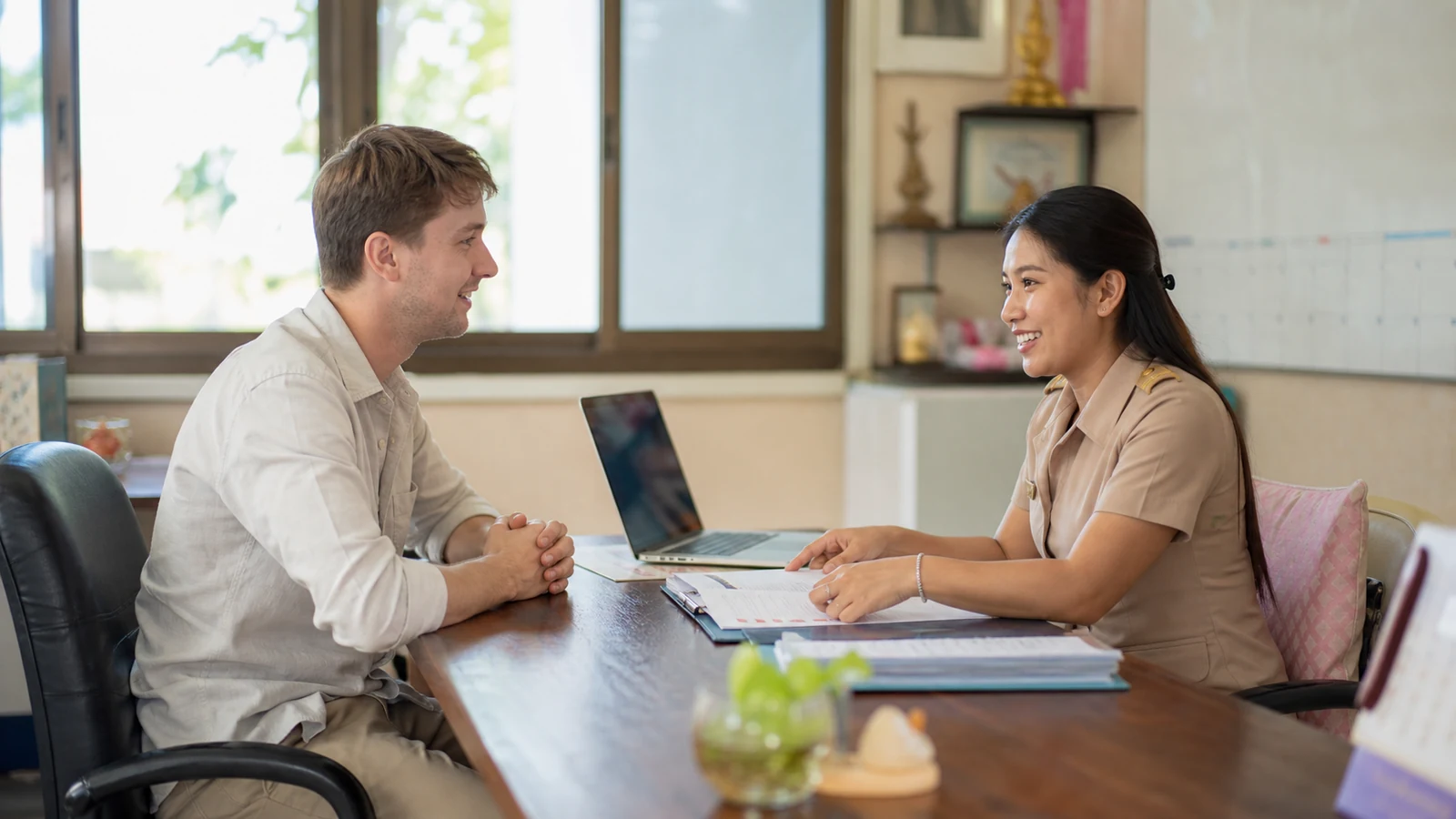 Foreign teacher receiving friendly onboarding support at a Thai school
